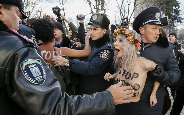 Ukrainian police detain activists of women's rights group Femen as they protest against homophobia outside the parliament building in Kiev, Ukraine, November 12, 2015. (Photo by Gleb Garanich/Reuters)