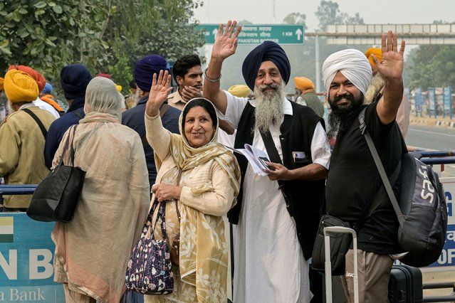 Indian Sikh pilgrims wave as they head to Pakistan through the India-Pakistan Wagah border in Wagah on November 4, 2025, on the eve of celebrations marking the birth anniversary of Guru Nanak, founder of Sikhism. Indian Sikh pilgrims have been issued visas for neighbouring Pakistan, the first major allowance after travel between the arch-rival nations was frozen during conflict in May. (Photo by Narinder Nanu/AFP Photo)