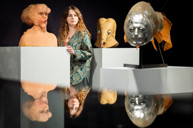 Gallery staff oversee (L-R) The Elephant Man: An Original Production Reference Bust of John Merrick (estimate £6000 - £8000), Dune: A Second Stage Guild Navigator Head (estimate (£1500 - £2000) and Monty Python/Graham Chapman: The Original Fish Model from The Meaning of Life (estimate £10,000 - £15,000) on display at “The Uncanny Sale” at Bonhams on October 27, 2025 in London, England. (Photo by Ben Montgomery/Getty Images)