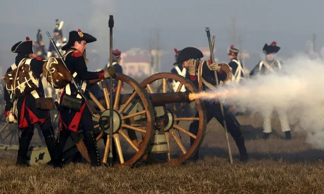 History enthusiasts, dressed as soldiers, fire a fake cannon during the re-enactment of Napoleon's famous battle of Austerlitz near the southern Moravian town of Slavkov u Brna December 5, 2015. (Photo by David W. Cerny/Reuters)
