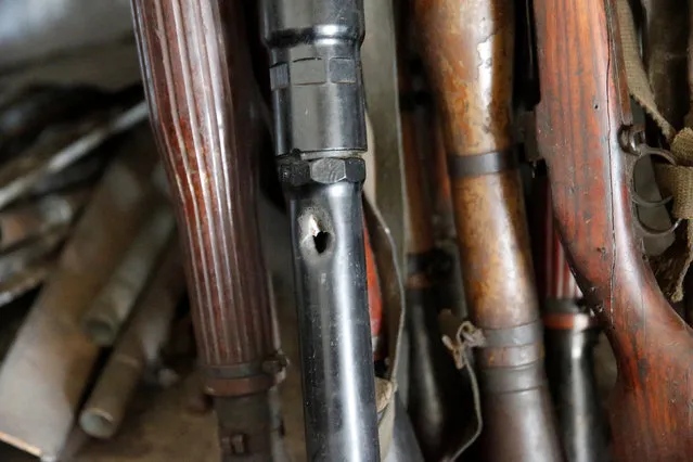 Damaged weapons arranged on a shelf in Mohammed Fadils workshop,outside of Erbil, Iraq November 6, 2016.  Picture taken November 6, 2016. (Photo by Marius Bosch/Reuters)