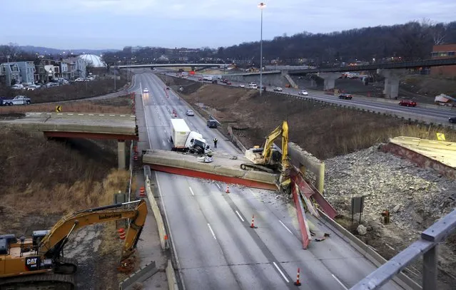 An early morning look of the aftermath of the bridge collapse on Interstate 75, Tuesday, Jan. 20, 2015 in Cincinnati, Ohio. The collapse killed a worker and injured a truck driver. The Ohio Department of Transportation said the busy artery through downtown Cincinnati will be closed at least two to three days. (AP Photo/The Enquirer, Liz Dufour)