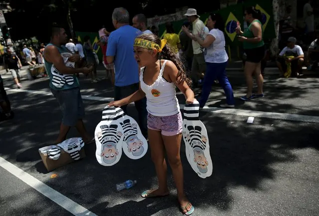 A girl sells inflatable dolls known as “Pixulecos” of Brazil's former president Luiz Inacio Lula da Silva during a protest calling for the impeachment of Brazil's President Dilma Rousseff in Sao Paulo, Brazil, December 13, 2015. (Photo by Nacho Doce/Reuters)