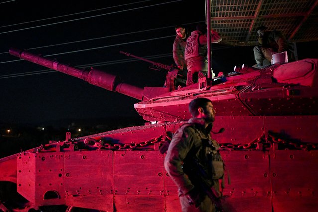 Israeli soldiers gather near a military vehicle after returning from Lebanon, following a ceasefire between Israel and Iran-backed group Hezbollah, near Kiryat Shmona and Israel's border with Lebanon in northern Israel on December 11, 2024. (Photo by Rami Shlush/Reuters)