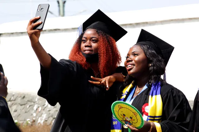 Students pose for a selfie during their graduation ceremony at the Stella Maris University campus amid the COVID-19 pandemic, in Monrovia, Liberia, 29 January 2021. The Stella Maris Polytechnic is a private institution of higher learning and operated by the Catholic Archdioces of Monrovia. (Photo by Ahmed Jallanzo/EPA/EFE)