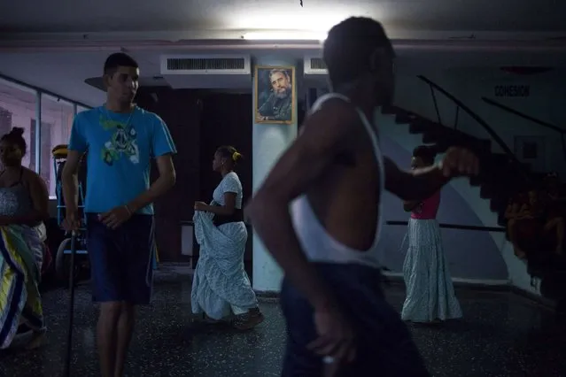 People rehearse a contemporary Haitian dance under a picture of Cuban former president Fidel Castro in a communal center in downtown Havana, January 30, 2015. (Photo by Alexandre Meneghini/Reuters)
