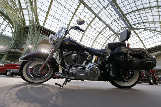 A Harley-Davidson motorcycle blessed with the signature of Emeritus Pope Benedict XVI, and later received by Pope Francis, is displayed ahead of the Bonhams' Les Grandes Marques du Monde vintage motor cars and motorcycles auction at the Grand Palais exhibition hall as part of the Retromobile vintage car show in Paris February 4, 2015. (Photo by Gonzalo Fuentes/Reuters)