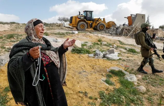 A Palestinian woman reacts as Israeli forces demolish her house near Hebron in the Israeli-occupied West Bank on March 2, 2021. (Photo by Mussa Qawasma/Reuters)
