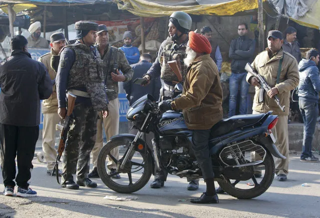 Indian security men stop a commuter  outside the Pathankot air force base in Pathankot, India, Sunday, Jan. 3, 2016. Combing operations to secure the Indian air force base where a group of militants started an attack before dawn on Saturday were continuing late Sunday morning. (Photo by Channi Anand/AP Photo)