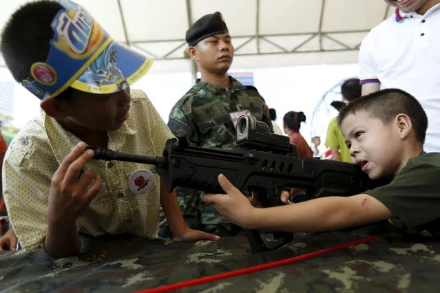 Children play with weapons during the Children's Day celebration at a military facility in Bangkok, Thailand January 9, 2016. (Photo by Jorge Silva/Reuters)
