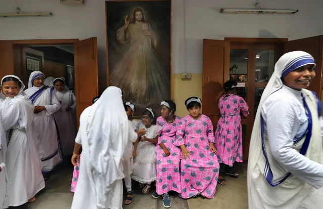 Nuns and children wait for the start of a mass prayer celebrating the 113th birth anniversary of Mother Teresa at the Mother House in Kolkata, India, 26 August 2023. It is Mother Teresa's first birthday celebration in Kolkata after her canonization by Pope Francis in 2016. (Photo by Piyal Adhikary/EPA)