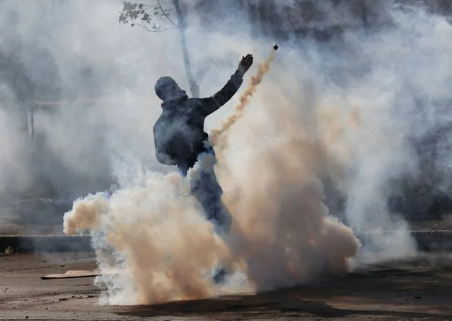 A Palestinian protester hurls back a tear gas canister fired by Israeli troops during clashes in the West Bank city of Bethlehem January 13, 2016. (Photo by Ammar Awad/Reuters)