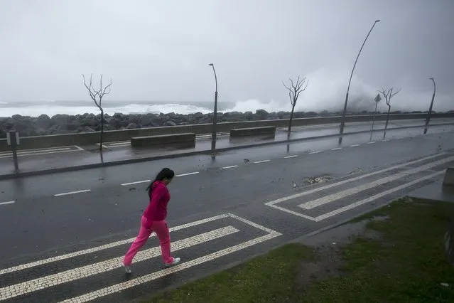 A woman walks on the street during the passage of hurricane Alex in Ponta Delgada, Azores, Portugal, January 15, 2016. (Photo by Rui Soares/Reuters)