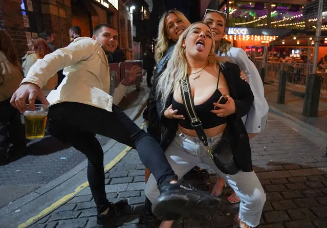 Revellers showed their excitement at being allowed back inside pubs in Leeds in northern England on May 17, 2021, as Covid-19 lockdown restrictions ease. (Photo by London News Pictures)