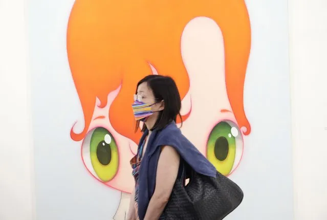 A visitor walks past at an artwork “To be honest, 2021” created by Spanish artist Javier Calleja at Art Basel in Hong Kong Wednesday, May 19, 2021. (Photo by Vincent Yu/AP Photo)