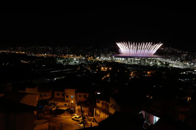 The Maracana Olympic Stadium during the opening ceremony is seen from the Mangueira favela slum during the Rio Olympic Opening Ceremony August 5, 2016. (Photo by Ricardo Moraes/Reuters)