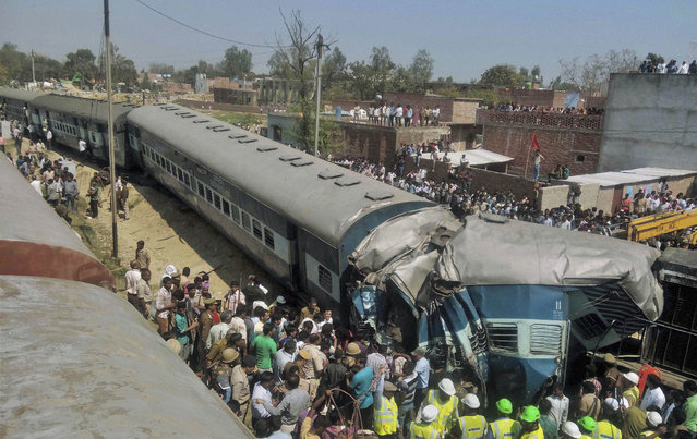 Indian rescue workers gather at the site of a train accident near Bachhrawan village in Uttar Pradesh state, India, Friday, March 20, 2015. Three coaches of a passenger train derailed Friday in northern India. (Photo by AP Photo/Press Trust of India)
