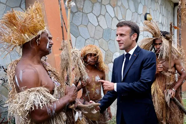 French President Emmanuel Macron attends a welcome ceremony with traditional dancers and warriors at the local Senate in Noumea on July 25, 2023. (Photo by Ludovic Marin/Pool via AFP Photo)