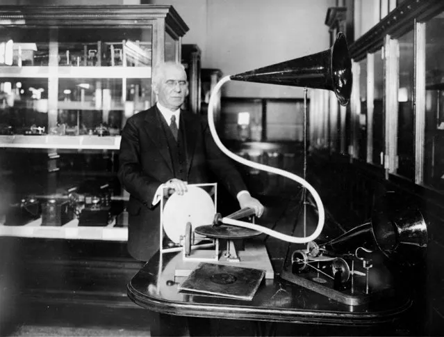 Emile Berliner, inventor of the phonograph and phonograph record, aka, gramophone, poses with his first phonograph machine, first exhibited in 1893, at the National Museum in Washington, D.C., February 21, 1921. The phonograph is the direct ancestor of the Victrola of today and still plays despite its 27 years. (Photo by AP Photo)