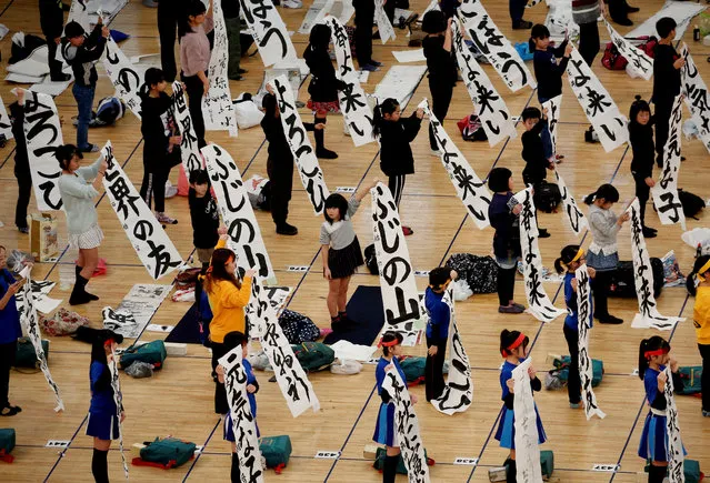 Participants show off their writings during a New Year calligraphy contest in Tokyo, Japan, January 5, 2019. (Photo by Kim Kyung-Hoon/Reuters)