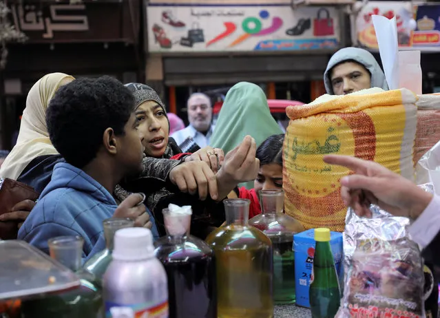 Customers buy natural herbal drugs and consumer goods from a herbal store in Cairo, Egypt January 10, 2017. (Photo by Mohamed Abd El Ghany/Reuters)