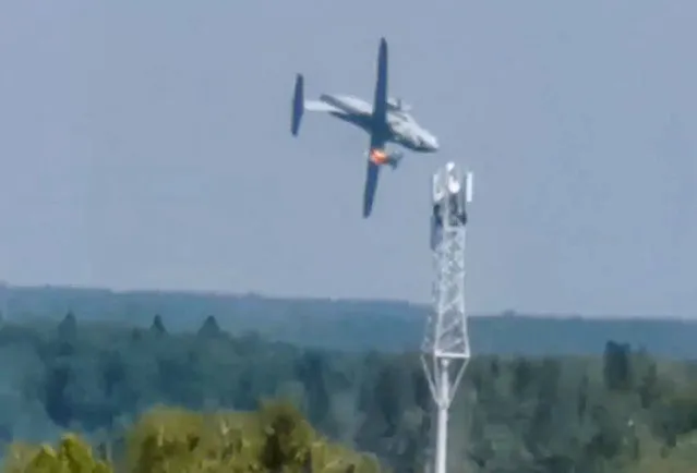 The new light military transport burning plane Il-112V flies down near Kubinka airfield about 45 kilometers (28 miles) west of Moscow, Russia, Tuesday, August 17, 2021. A prototype military transport plane crashed while performing a test flight outside Moscow on Tuesday, Russian news agencies reported, citing Russia's United Aircraft Corporation. The new light military transport plane, Il-112V, crashed in a forested area as it was coming in for a landing at the Kubinka airfield about 45 kilometers (28 miles) west of Moscow, spokespeople of the corporation told the TASS news agency. (Photo by Dmitry Ovchinnikov via AP Photo)
