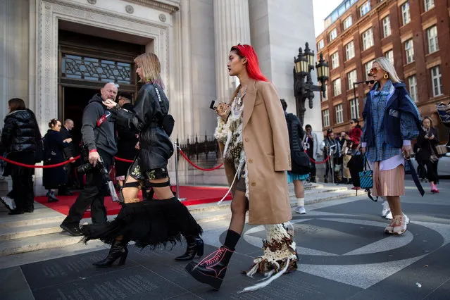 People on the street outside the Fashion Scout show space during the London Fashion Week 2019, in Central London, Britain, 17 February 2019. (Photo by Tom Nicholson/EPA/EFE)