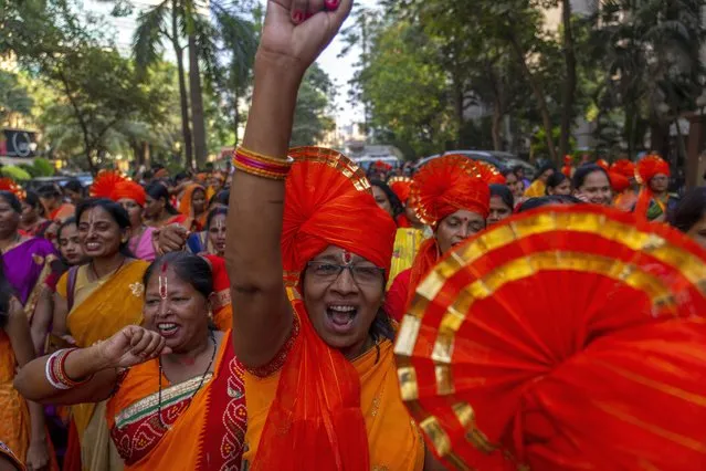 Hindu women chant holy slogans to celebrate the upcoming opening of a grand temple for the Lord Ram, in India's northern Ayodhya city during a procession in Mumbai, India, Sunday, January 21, 2024. (Photo by Rafiq Maqbool/AP Photo)