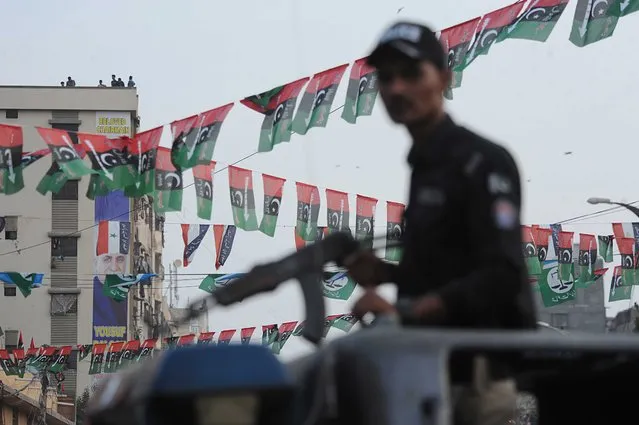 Armed police stands guard as supporters of Pakistan Peoples Party (PPP) attend an election campaign ahead of the general elections in Karachi, Pakistan, 05 February 2024. The Election Commission of Pakistan (ECP) has announced that general elections for the parliament and four provincial assemblies are scheduled to take place on 08 February 2024. The National Assembly comprises of 266 general and 70 reserved seats. (Photo by Shahzaib Akber/EPA/EFE)