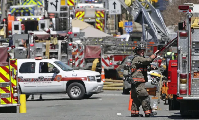 Firefighters and emergency personnel work the scene of an explosion and building fire in downtown Durham, N.C., Wednesday, April 10, 2019. (Photo by Gerry Broome/AP Photo)