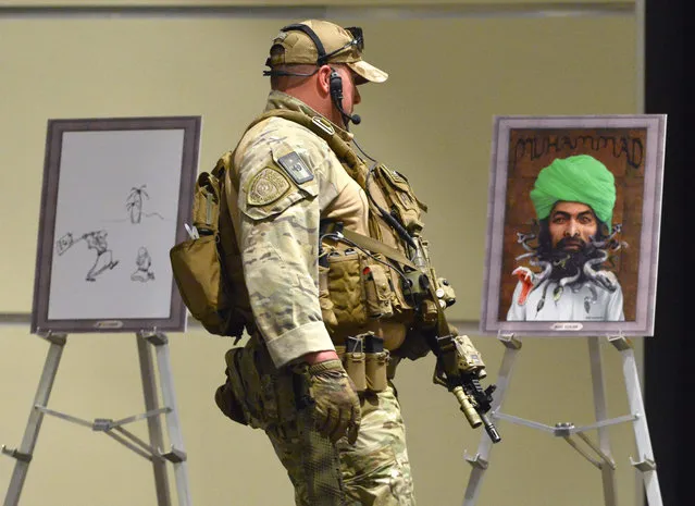 Heavily armed police secure art work before the Dutch member of parliament and leader of the far-right Party for Freedom, Geert Wilders delivers the keynote address at the Muhammad Art Exhibit and Contest at the Curtis Culwell Center in Garland, Texas, USA, 03 May 2015. The art exhibit is being put on by the Pamela Geller's American Freedom Defense Initiative. (Photo by Larry W. Smith/EPA)