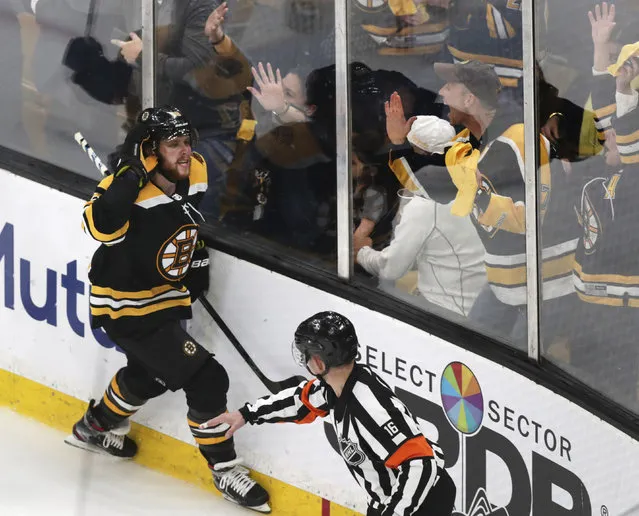 Boston Bruins right wing David Pastrnak (88) celebrates with fans after his goal off Columbus Blue Jackets goaltender Sergei Bobrovsky (not shown) during the third period of Game 5 of an NHL hockey second-round playoff series, Saturday, May 4, 2019, in Boston. (Photo by Charles Krupa/AP Photo)