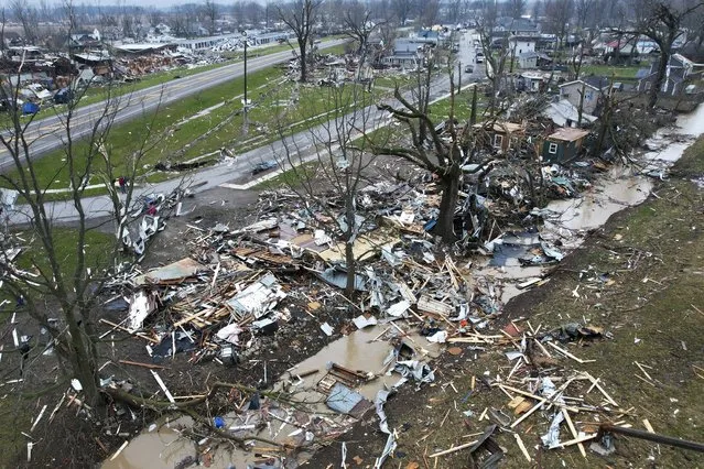 Debris scatters the ground near damaged homes following a severe storm Friday, March 15, 2024, in Lakeview, Ohio. (Photo by Joshua A. Bickel/AP Photo)