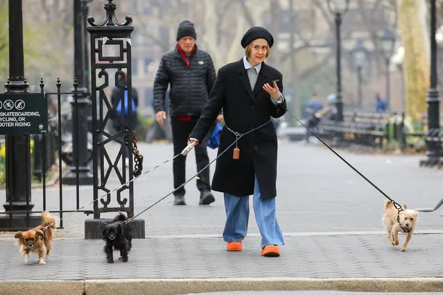 Sarah Paulson spotted taking a stroll with her 3 dogs in New York City on March 26, 2024. The American actress wore a knit beanie, black trench coat, jeans, and UGG Tasman Weather Hybrid Slippers. (Photo by The Image Direct)