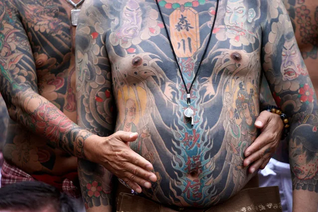 Participants pose showing traditional Japanese tattoos during the annual Sanja Matsuri festival in Tokyo's Asakusa district, Japan, 19 May 2019. Around two million people gathered in Asakusa streets during the three-day spring festival, one of Japan's biggest festivals. (Photo by Franck Robichon/EPA/EFE)