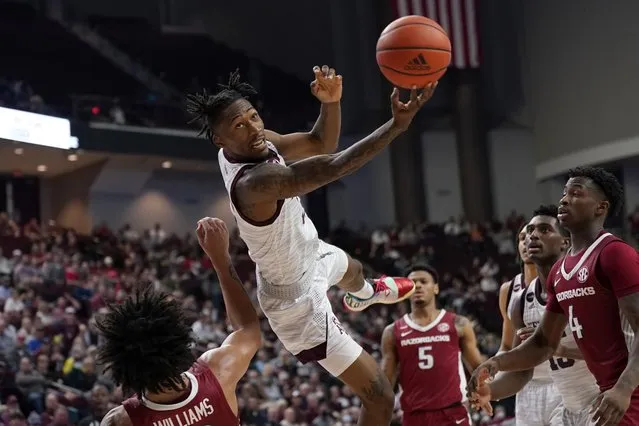 Texas A&M guard Quenton Jackson (3) tries to make a basket after being fouled by Arkansas forward Jaylin Williams (10) during the second half of an NCAA college basketball game Saturday, January 8, 2022, in College Station, Texas. (Photo by Sam Craft/AP Photo)