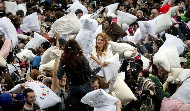 Revelers take part in a giant pillow fight on the north terrace of Trafalgar Square on “International Pillow Fight Day” in London. (Photo by Rob Stothard/Getty Images)