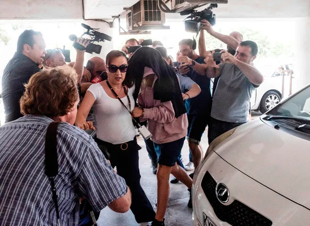 This picture taken on July 29, 2019 shows a British teenager who accused seven Israelis of gang rape arriving at the Famagusta District Court in Paralimni in eastern Cyprus, to face charges of making a false allegation. Initially, the 19-year-old woman had alleged that 12 Israelis gang raped her at the hotel where she was staying in the popular Ayia Napa resort on July 17. The young Israeli tourists were remanded in custody the next day. But hours before their second appearance in court five of them were released and sent home late the next day. (Photo by Iakovos Hatzistavrou/AFP Photo)