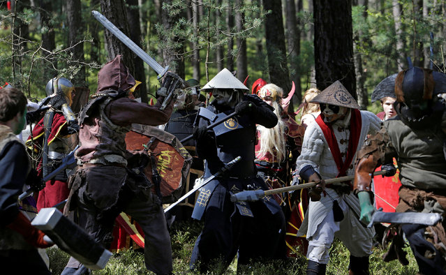 People dressed as characters from the computer game “World of Warcraft” fight during a battle near the village of Sosnova, Czech Republic, April 30, 2016. (Photo by David W. Cerny/Reuters)