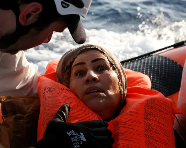 A migrant reacts after being rescued by the Malta-based NGO Migrant Offshore Aid Station (MOAS) after they were spotted adrift on board a wooden boat in the central Mediterranean north of Sabratha on the Libyan coast, April 5, 2017. (Photo by Darrin Zammit Lupi/Reuters)