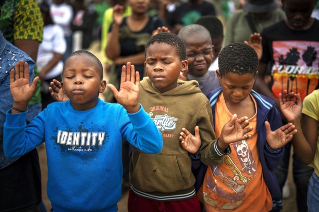 Children pray during an election meeting organized by Ukhonto weSizwe party in Mpumalanga, near Durban, South Africa, Saturday, May 25, 2024, ahead of the 2024 general elections scheduled for May 29. (Photo by Emilio Morenatti/AP Photo)