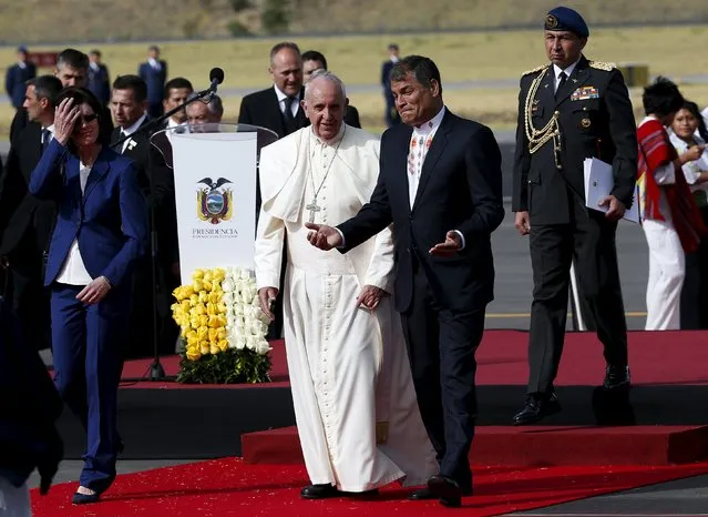 Pope Francis (C) is greeted by Ecuador's President Rafael Correa (R) and his wife Anne Malherbe Gosseline (L) after he landed in Quito, Ecuador, July 5, 2015. Pope Francis landed in Ecuador's capital Quito on Sunday to begin an eight-day tour of South America that will also include visits to Bolivia and Paraguay. (Photo by Alessandro Bianchi/Reuters)