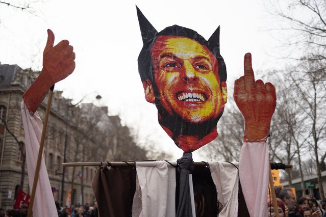 People hold a muppet of Emmanuel Macron as they take part in a demonstration on a 8th day of strikes and protests across the country against the government proposed pensions overhaul in Paris on March 15, 2023. France faces another day of strikes over highly contested pension reforms which President appears on the verge of pushing through despite months of protests. As the legislation enters the final stretch in parliament, trade unions are set to make another attempt to pressure the government and lawmakers into rejecting the proposed hike in the retirement age to 64. (Photo by Lafargue Raphael/ABACA/Rex Features/Shutterstock)