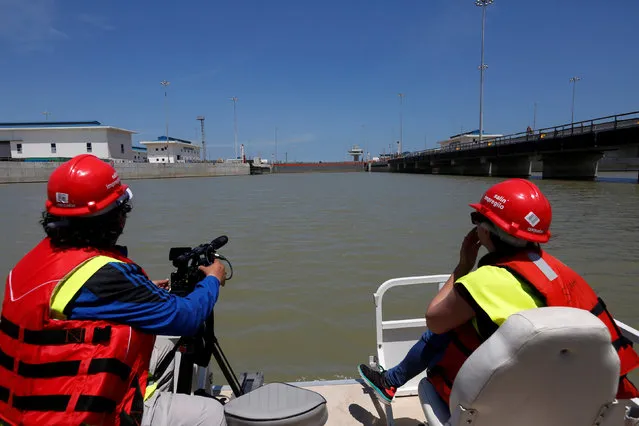 Members of the media film the new the Panama Canal expansion project on the Pacific side of the Panama Canal during an organized media tour by Italy's Salini Impregilo, one of the main sub contractors of the Panama Canal Expansion project, in Panama City May 11, 2016. (Photo by Carlos Jasso/Reuters)