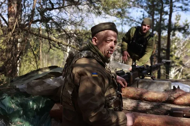 Ukrainian servicemen guard their position near Brovary, north of Kyiv, Ukraine, Thursday, March 17, 2022. (Photo by Serhii Nuzhnenko/AP Photo)