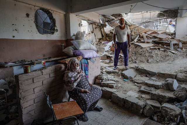 Hussein Abu Assi, right, stands inside his house in Bani Suheila, Gaza, on Wednesday, July 17, 2024. It was heavily damaged by Israeli bombardment amid Israel’s war against the Palestinian militant group Hamas. (Photo by Bashar Taleb/AFP Photo)