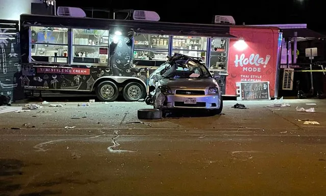 A damaged vehicle sits in front of a food truck following a collision in Austin, Texas on Friday, April 8, 2022. Authorities say multiple people were injured in the “major collision” involving pedestrians and two vehicles, one of which hit the food truck. (Photo by Acacia Coronado/AP Photo)