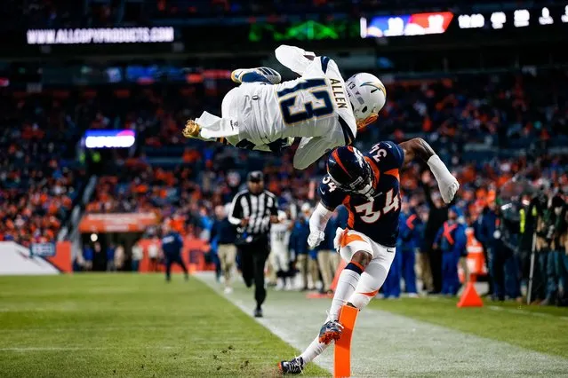 Los Angeles Chargers wide receiver Keenan Allen dives for a touchdown against Denver Broncos strong safety Will Parks in the fourth quarter in Denver, December 1, 2019. (Photo by Isaiah J. Downing/USA TODAY Sports)