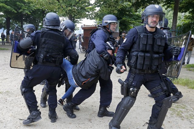 French CRS riot police apprehend a demonstrator during clashes during a demonstration in Paris as part of nationwide protests against plans to reform French labour laws, France, June 14, 2016. (Photo by Jacky Naegelen/Reuters)