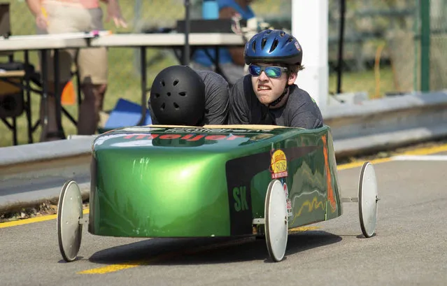 Elex Eaton and his co-pilot race in the Super Kids division of the annual Truist All-American Soap Box Derby on the J. Mac Yowell Soap Box Derby Track at Phil Moore Park in Bowling Green, Ky., on Saturday, May 21, 2022. (Photo by Grace Ramey/Daily News via AP Photo)